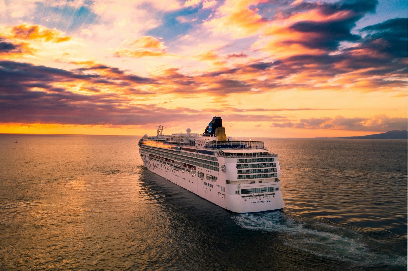 A cruise ship at sea at sunset